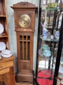 1920's/30's oak longcase clock having circular brass dial, 180cm.