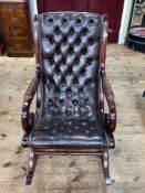 Brown deep buttoned and studded leather rocking chair.