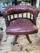Late Victorian Captains style swivel desk chair in red studded hide.