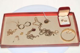 Collection of gold jewellery including chain necklace, bracelet, locket and earrings.