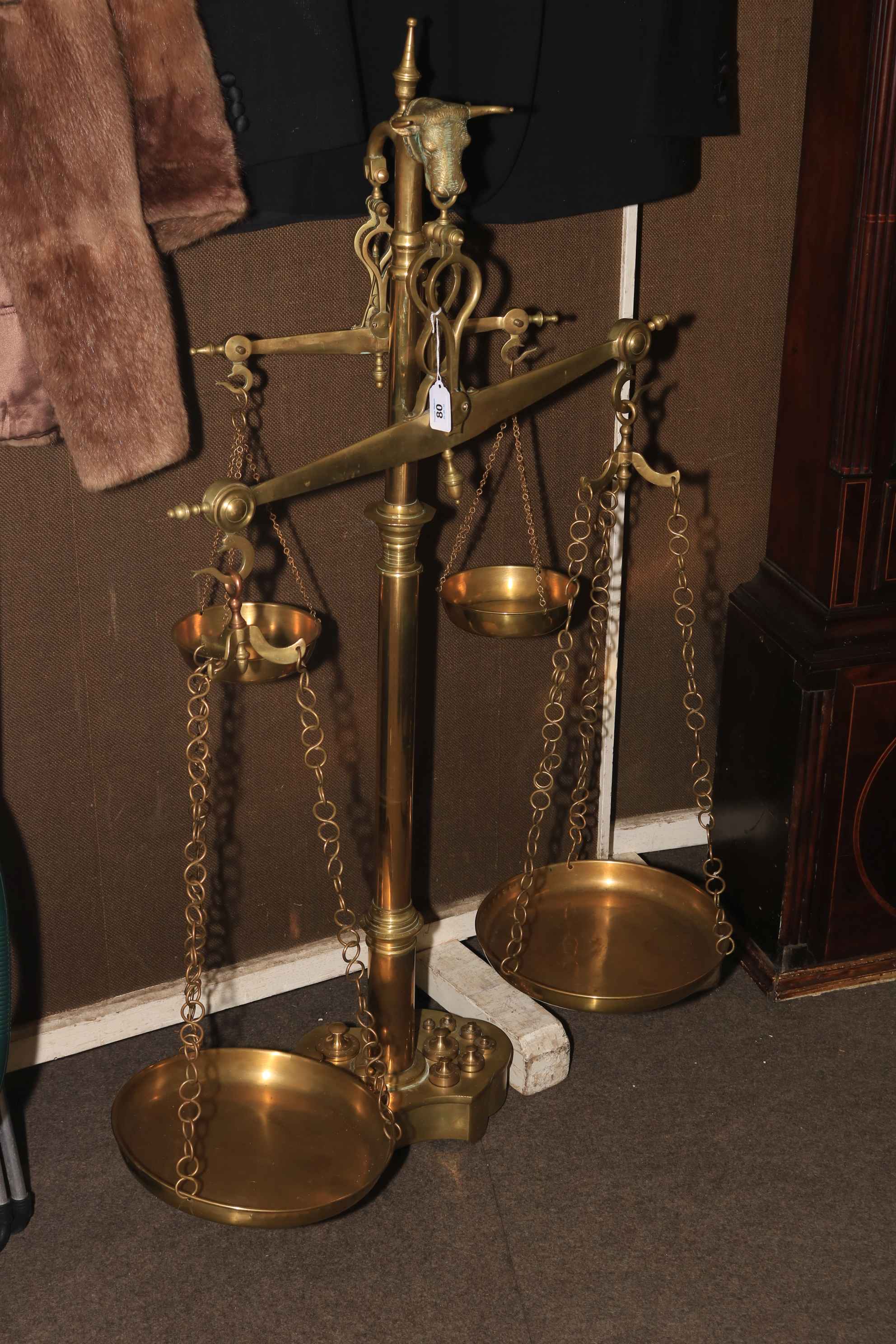 Large brass set of twin balance scales with a set of integrated weights.