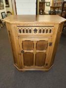 Oak canted corner side cabinet, 91cm by 80cm by 48cm.