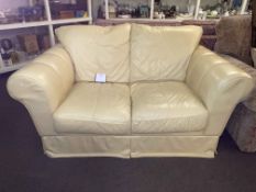 Ivory leather two seater settee.