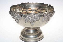Large silver plated punch bowl with grape and vine decoration.