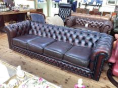 Ox blood deep buttoned leather four seater Chesterfield settee, 70cm by 234cm by 91cm.