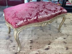 Large gilt framed stool of serpentine form, 62cm by 110cm by 65cm.