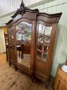 French oak breakfront armoire having central mirror door flanked by two mirror panelled doors above