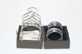 Silver five bar toast rack and pair of napkin rings, boxed.