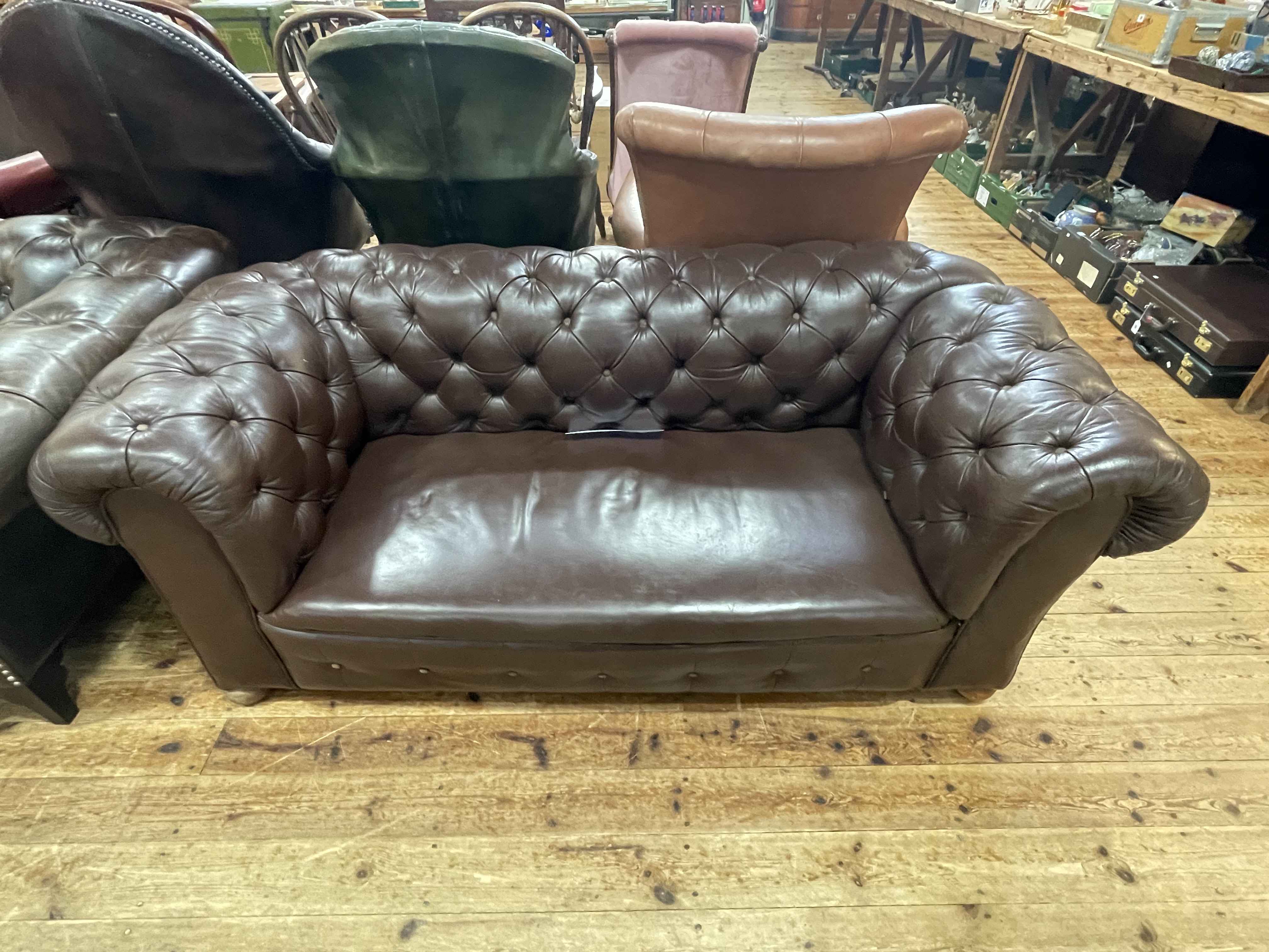 Brown buttoned leather drop end Chesterfield settee.