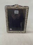 Embossed silver easel photograph frame.