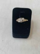 9 carat gold three white stone crossover ring, size T.