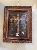 Rectangular gilt framed crucifix behind domed glass, 31cm by 25cm.