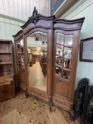 French oak breakfront armoire having central mirror door flanked by two mirror panelled doors above