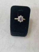 Amethyst and diamond cluster 18 carat white gold ring, size O.