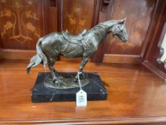 Bronzed effect model of a saddled horse on a marble plinth, 25cm high.