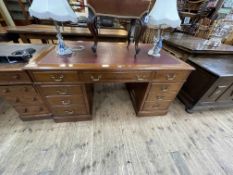Early 20th Century mahogany eight drawer pedestal desk with burgundy and gilt tooled leather inset