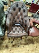 Brown deep buttoned leather swivel office armchair.