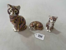 Three Royal Crown Derby cat paperweights.