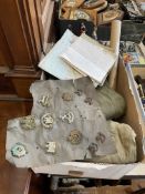 Box of military items in cap badges, maps,