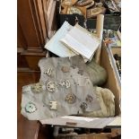 Box of military items in cap badges, maps,