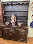 Antique oak dresser, the shelf back above two drawers and two cupboard doors,