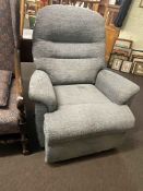 Manual reclining chair in blue/grey fabric.