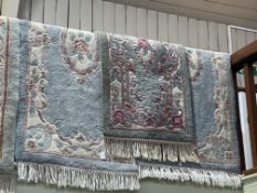 Collection of three Chinese rugs including pair blue and floral patterned 1.60 by 0.