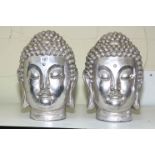 Pair of silvered Buddha heads.