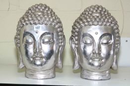Pair of silvered Buddha heads.