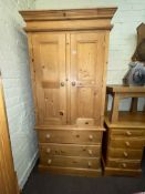 Pine combination wardrobe having two doors above three drawers and similar eight drawer pedestal