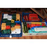 Four boxes of vintage toy vehicles including buses and ambulances.
