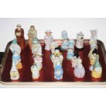 Collection of twenty one Royal Worcester figure candle snuffers.