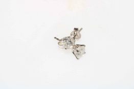 Pair of 18 carat white gold and brilliant cut diamond stud earrings, approximately 1.07 carats.
