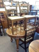 Edwardian oval mahogany extending dining table, leaf and winder, four ladder back dining chairs,