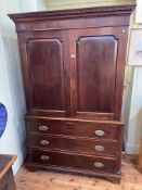 Antique mahogany linen press having two fielded panel doors above one faux and two long drawers on