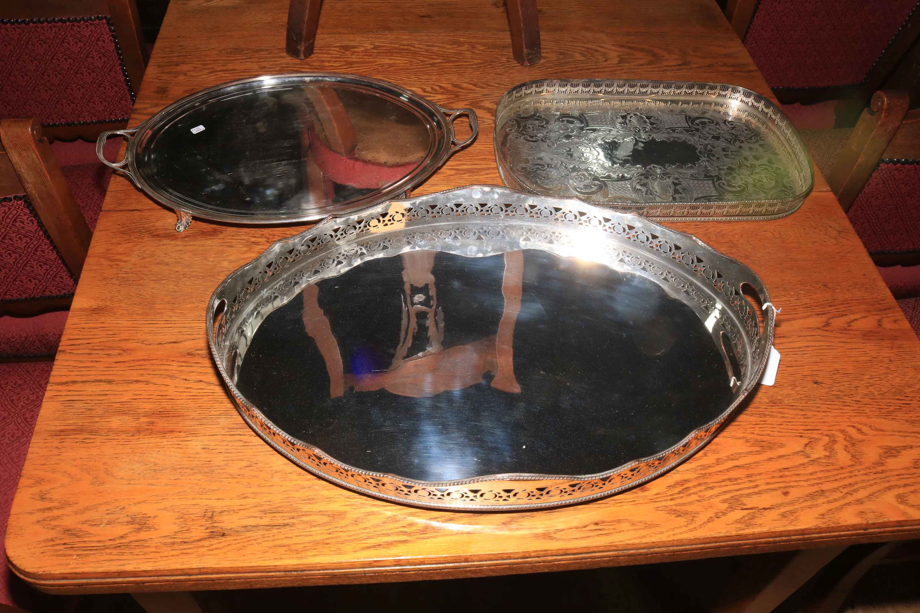 Three silver plated serving trays.