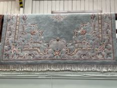 Pale green and floral patterned Chinese carpet 3.20 by 2.10.