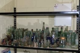Large collection of vintage glass bottles.