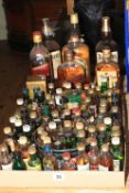 Seven bottles of whisky and approximately eighty miniatures including Teacher's 75cl, Bell's 75cl,