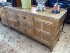 Don Craven 'Foxman' adzed oak sideboard having three central drawers flanked by two cupboard doors,