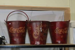 Three marked 'Coca Cola' buckets.