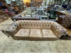 Light brown Saxon leather and studded four seated Chesterfield settee.