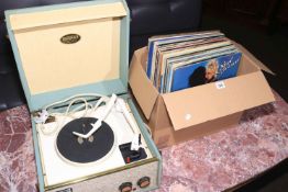 Dansette table top record player with a box of LP records.