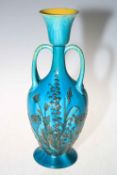 Large Linthorpe Pottery twin handle vase with raised floral design on blue ground, number 2141,