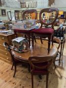 Victorian mahogany circular dining table on pedestal tripod base together with a set of six balloon