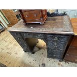 Victorian carved oak nine drawer pedestal desk, 96.5cm by 107cm by 53cm.