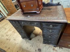 Victorian carved oak nine drawer pedestal desk, 96.5cm by 107cm by 53cm.