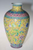 Large Chinese yellow ground vase with floral design with Qianlong mark to base, 33.5cm high.