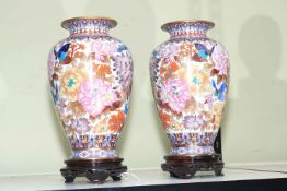 Pair of Cloisonné vases on wood stands.