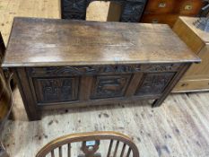 Antique carved oak triple panel front coffer, 69cm by 143cm by 57cm.